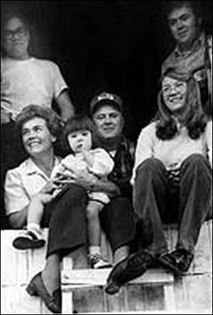 Mr. and Mrs. Miller surrounded by their children: Dave (clockwise from top left), Mick, Sandy, and Lori in her mother's lap.