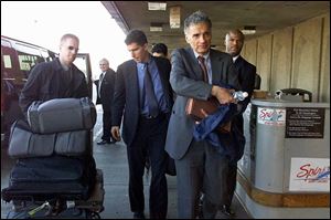 Green Party candidate Ralph Nader heads for a flight in Detroit. His support in Michigan may affect the presidential race.