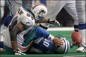 Miami's Jason Taylor, who had two sacks, checks out Lions QB Charlie Batch after a sack in the third quarter. Batch left with a mild concussion and was replaced by Stoney Case.