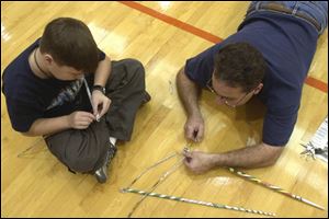 Kevin Seyfried, 12, of Whiteford Agricultural School in Ottawa Lake, Mich., and his father, Larry, build a tower using only two newspapers. Mr. Seyfried is a teacher at Whitmer High School.