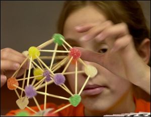 Katie Elsass, 13, of Lima makes a dome from gumdrops and toothpicks during the build-a-thon in Bowling Green.