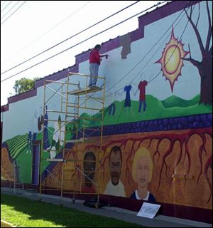 The 92-foot-long mural depicts the culture and the history of Lenawee County.