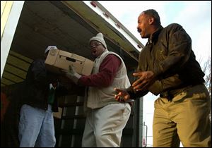 Residents of the Life Transformation program load turkeys into a truck as agencies prepare holiday feasts for the needy.