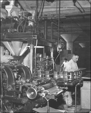 Workers run machines to bag Eight O'Clock brand coffee in 1936; the Toledo roasting plant operated here until 1998.