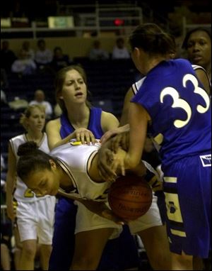 Toledo's Melantha Herron battles Indiana State's Kourtney Mennen for a rebound last night. The Sycamores trailed 31-14 but tied it at 33 at halftime.