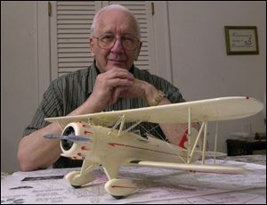 John Blank with a model that a man gave to him. Mr. Blank founded the Toledo Model Airplane Supply Co. in 1934, but World War II forced him out of business.