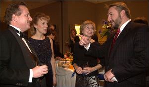 SCHOOL TIES: Chairman Tom and Connie Schmidt, left, with Robin and Dick LaValley at the Notre Dame benefit.