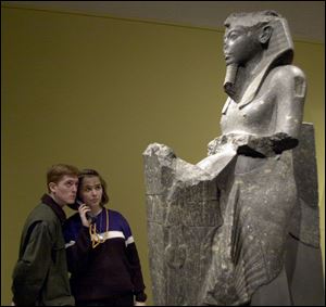 Matt Eldred, of Grand Rapids, Mich., and Andrea Chadwell, of Adrian, share an audio guide as they learn about the statute `Tutankhamun Presenting Offerings' in the exhibit at the Toledo Museum of Art.