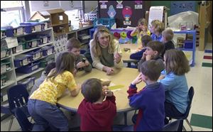 Jennifer Hare and kindergarteners at Douglas Road Elementary discuss vegetables before they prepare soup.