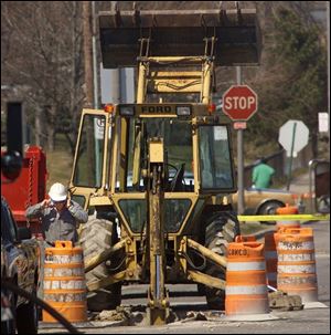 Utility crews work to shut down the natural gas leak at Canton Avenue and State Street.