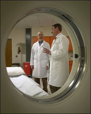 Judge Charles Wittenberg, left, gets an overview of the computer tomography imaging technology at St. Vincent Mercy Medical Center from Dr. Richard Siders.