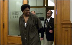 Joseph Green flashes a smile to family as he enters the courtroom to face the judges who would determine his fate.