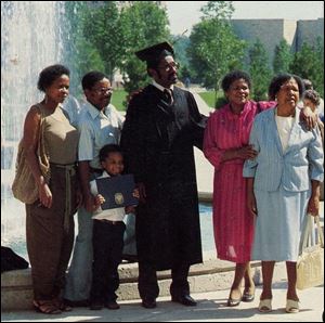In 1984, Roberto Baccus-Williams, the little guy at left, snatched his uncle's diploma. 