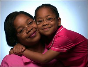 Charon Miller and her daughter, Imani. Since 1986, Ms. Miller has cared for Imani and received her bachelor's and master's degrees.