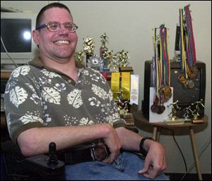 Dann Poling, surrounded by some of his awards, will be in the northwest Ohio delegation at the Special Olympics precursor.