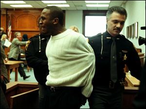 Karl Willis is led from court after his aggravated murder conviction. This Diane Hires photo won a first place in the Ohio Associated Press competition.