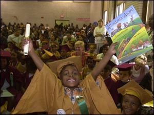 Life is good when you are 6 and just graduated from kindergarten  at Washington Kendergarten Center on Palmwood Ave. in Toledo as Lemuel Edwards shows us. He also has an attendance award to go with his diploma. Dutton CTY kinder04p 1 JUNE 4 2001