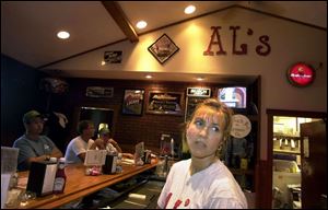 Mary Barhorst, owner of Al's Bar and Grill in Fort Loramie, Ohio, serves a hectic breakfast to customers in town for the concert. Ms. Barhorst said this is the first year the restaurant opened for breakfast to take advantage of the concert crowd, and she was glad to see the weekend end.