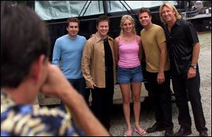 Members of Lonestar pose for a fan's photo backstage.