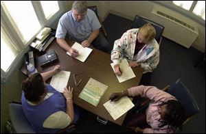 At shift change, staff members, from top, Steve Huber, Karen Adrian, Patricia Shipp, and Pam Henderson exchange notes.