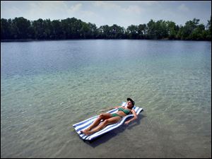 REG regrov23 02 - 072301. Karen Swander enjoys the solitude she is afforded by enjoying her own private quarry in Bascom, Ohio. The quarry used to be public, but was sold several years ago. Swanders parents now own the quarry and surronding farmland. The Blade/Allan Detrich