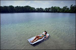 REG regrov23 02 - 072301. Karen Swander enjoys the solitude she is afforded by enjoying her own private quarry in Bascom, Ohio. The quarry used to be public, but was sold several years ago. Swanders parents now own the quarry and surronding farmland. The Blade/Allan Detrich