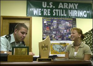 U.S. Army recruiter Sgt. Jeff Gilbert, left, who discusses military job prospects with Start High School senior Casey Cole, is part of the Army's renewed effort to enlist more northwest Ohioans.