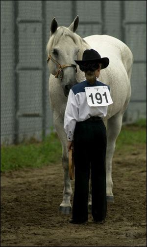 Nicole Krueger waits to show her horse, Mr. Bojangles, at the Monroe County Fair, which ended Sunday.