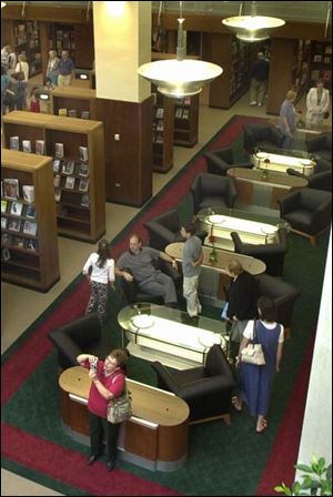 Tables made from old light fixtures attract visitors in the Popular Library, where new acquisitions will be displayed.