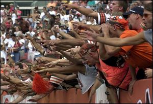 Fans in the 'Dawg Pound' at Cleveland Browns Stadium whoop it up before the Browns' home opener against the Seattle Seahawks.