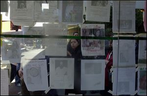 A bus kiosk becomes a wall of 'missing persons' posters near St. Vincent's Catholic Medical Center in New York City. Thousands of people are missing in the rubble of the trade center.