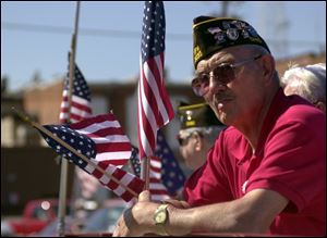 Veteran Hubert Grothouse watches the parade pass by as part of Canal Days in Delphos.