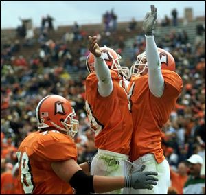 Bowling Green's Kurt Gerling, right, celebrates his third-quarter touchdown reception with David Bautista, center, and Dennis Wendel yesterday at Bowling Green.