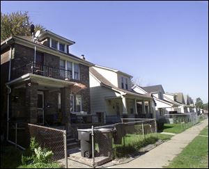 In the house, at left, three men were arrested on charges of possessing false immigration documents.