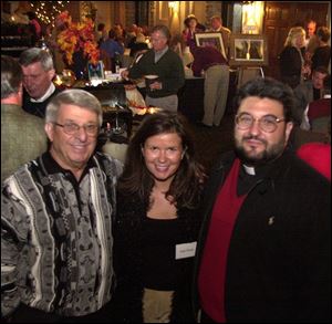 AT THE BISTRO: Tony Falzone, Susie Nowak, and The Rev. Michael Billian take a break from wine tasting at the party.
