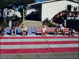 NBR L-R: Kathleen Lascala (glasses), Jessica Dauer, Amanda Ison, Kristen Germain, Autumn Jackson and Chelsey Koder. The girls chalked out a nice design of an American Flag, in their neighborhood using sidewalk chalk. handout photo