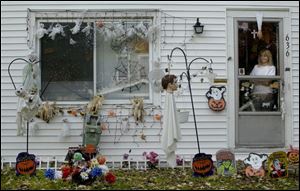 Susan Taylor admires her Halloween handiwork at her home on Oswald Street, which she decorates every holiday.