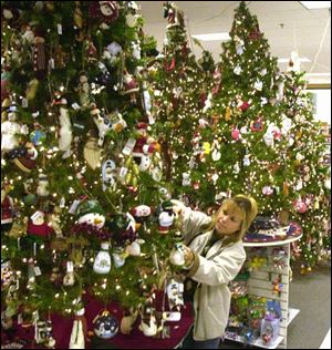 Toni Demoe, a supervisor at Kohl's on Monroe Street, arranges a Christmas display.