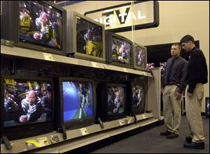 Felix Jagodinski, left, and Chad Croley, Bowling Green students, compare TVs at the Best Buy on Airport Highway.