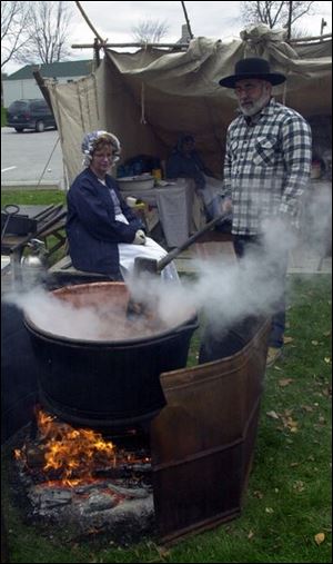 Dennis and Debra Billow of Clyde make apple butter at the annual Autumn Fest in downtown Pemberville.