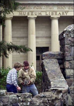 Paul Berringer, left, and Tom Lafever look over stones from gate pillars being rebuilt at the Hayes Presidential Center in Fremont.