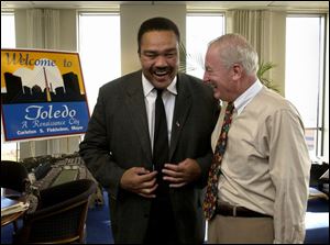 Mayor Carty Finkbeiner, right, congratulates Mayor-elect Jack Ford on the 22nd floor of One Government Center.
