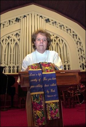 Tanya Pike, spiritual director of Toledo's Central United Methodist Church, displays the stole she cannot wear.
