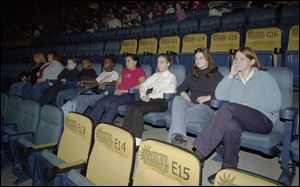 From left, Kellie Roberts, Deb Essing, Stephen Davis, Robert Oliver, Jasmine Boyd, Melaniya Woodward, Delaney and Casey Mahoney, and Meredith Tong, wait for the film to start.