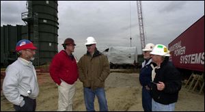 From left, George Stuller, Industrial Power Systems President Kevin Gray, Ray Linn, Larry McCauley and Bill Norris chat at the electric peaking plant in Troy Township.