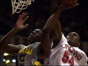 Toledo's Kareem Milson has his shot blocked by Cincinnati's Jason Maxiell during the first half last night.