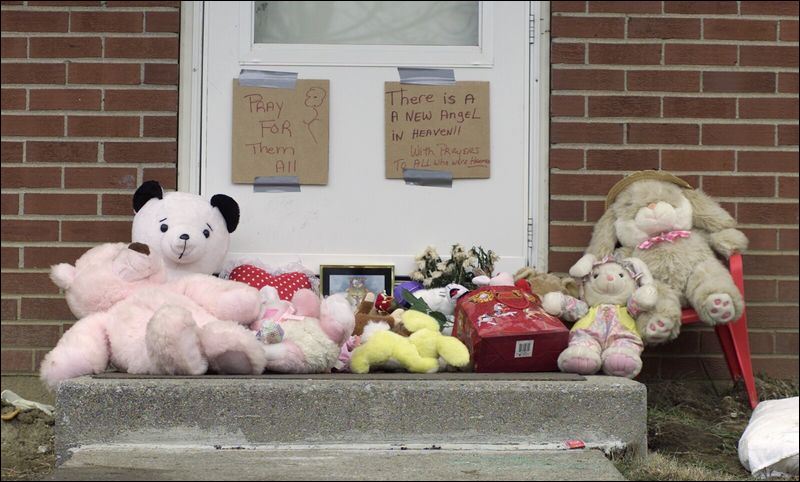 Stuffed animals and flowers are left at 503 Eureka St. in Lima, Ohio ...