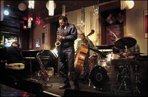 Murphy's is one of the places to find live music in downtown Toledo. Larry Smith on the alto saxophone sits in on a set with Bob White on the drums; Claude Black, piano, and Clifford Murphy, bass.