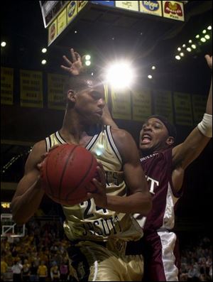 Scott's Stuart Sims defends against St.John's Brandon Barabino during the first half of the City League championship game last night at Savage Hall. The Titans rallied from 18 points down in the fourth quarter to defeat the defending champs for the second time this season.