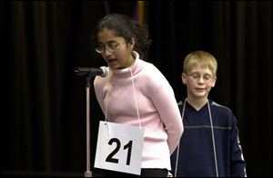 Priyanka Jain, an eighth grader at Ottawa Hills Junior High School, cor- rectly spells `peregrination' to win the bee at Owens Community College.